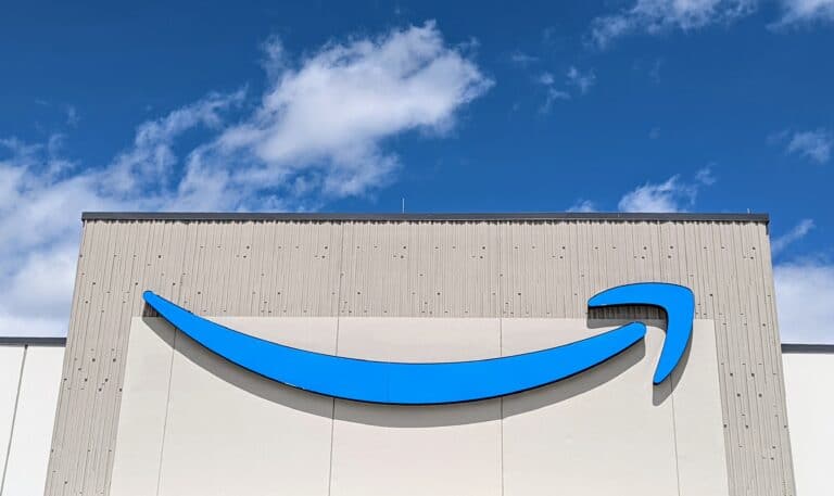 An Amazon sign above the entrance to a sortation center. (GeekWire File Photo / Todd Bishop)